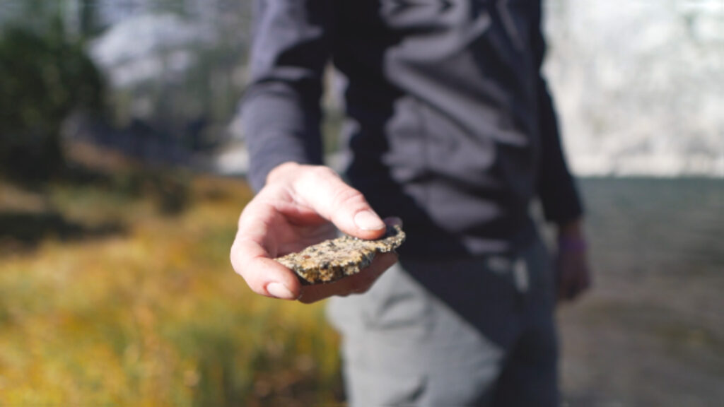 Holding a rock from an alpine lake