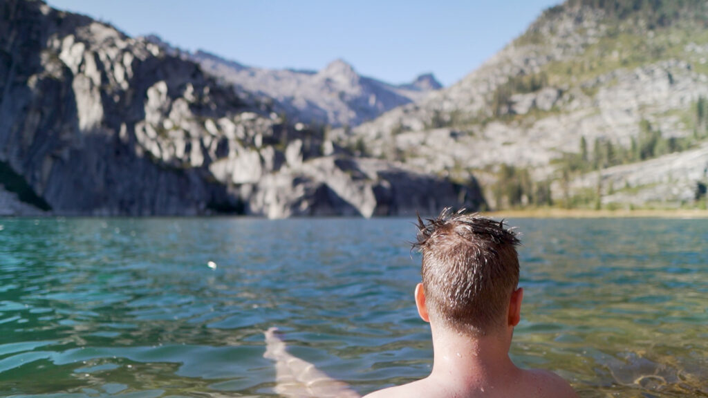 man sitting by lake