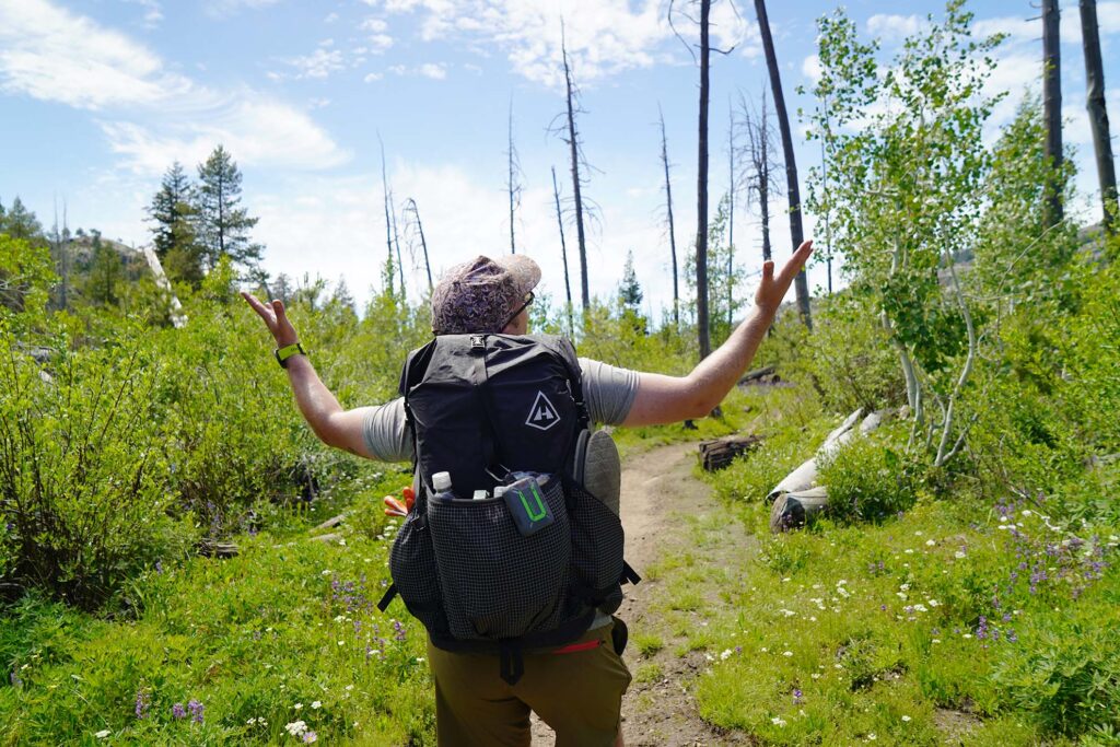 Man standing in wilderness with hyperlight mountain gear 2400 southwest backpack testing for a review